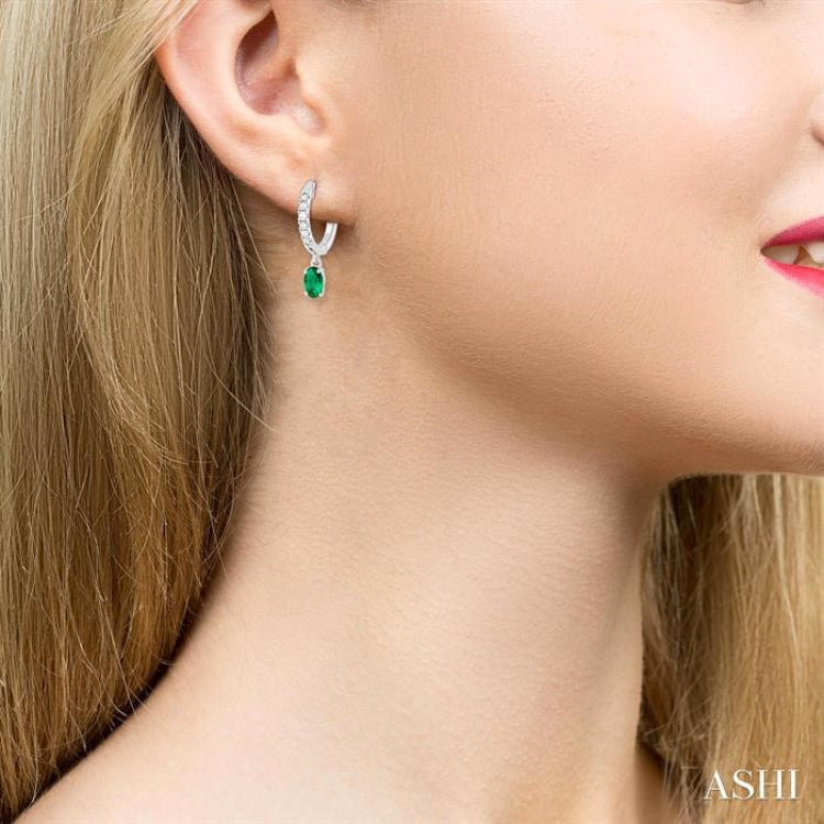 5x3 MM Oval Cut Emerald and 1/8 Ctw Petite Round Cut Diamond Precious Fashion Huggies in 10K White Gold