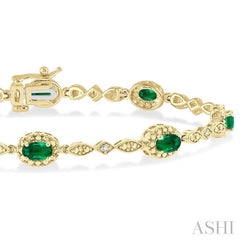 5x3 MM Oval Cut Emerald and 1/20 Ctw Round Cut Diamond Bracelet in 10K Yellow Gold